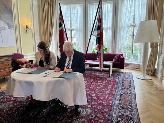 Fiskeri- og havminister Cecilie Myrseth og Lord Davies of Gower, Storbritannias juniorminister med ansvar for maritim transport, signerer en ny samarbeidsavtale om tettere maritimt samarbeid mellom Norge og Storbritannia.