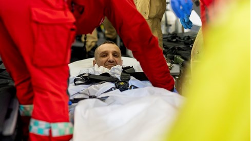 Ukrainian man on stretcher looks straight on camera