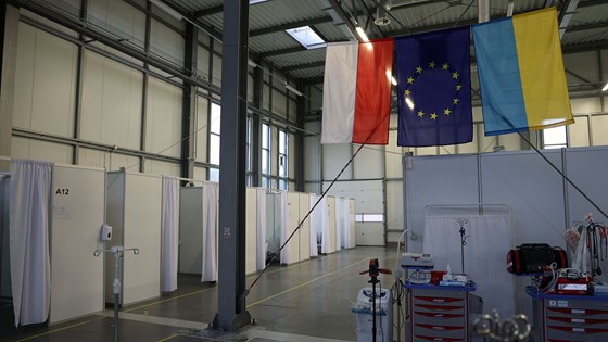 Polsk og ukrainsk flagg henger fra taket i medisinsk hub i Polen