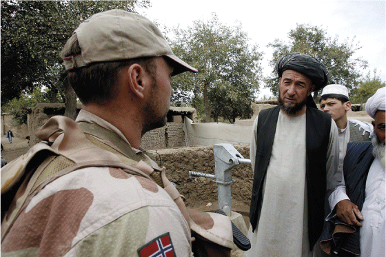 Figure 8.8 Norwegian soldiers conversing with the local population. Expectations were often high as to what Norwegian forces could accomplish. Early in the engagement Norwegian forces drilled wells for local communities, but this kind of activity was stopped, b...