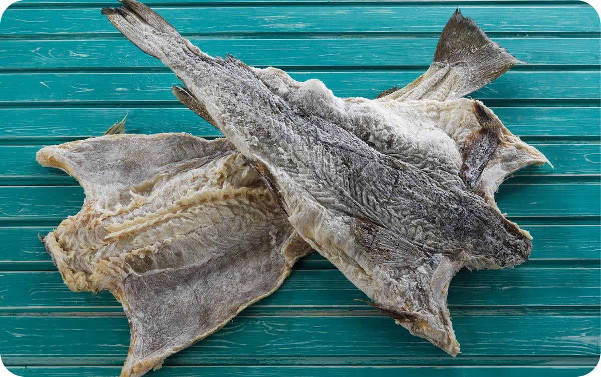 Two whole “clipfish” on a table. Clipfish is the most important seafood product exported from Norway to Brazil.