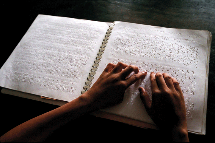 Figure 3.2 A blind child reading at a school in Bangladesh