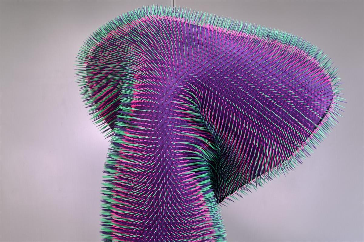 Doing nothing with AI by the Austrian artist Emanuel Gollob. A purple cactus-like figure with turquoise, rubber-looking spikes. Used with permission from Ars Electronica.
