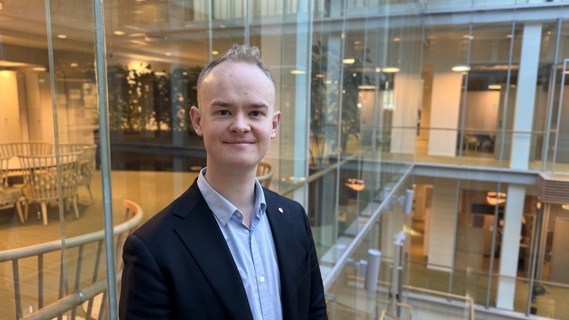 Statssekretær Kristoffer Hansen står i lokalene til Klima- og miljødepartementet