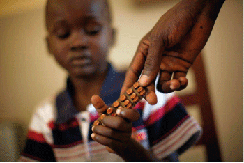 Figure 7.4 The UNDP works in many areas. Here, a young boy is given medicine for tuberculosis.