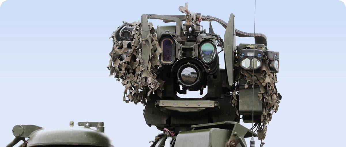 A weapon station facing the camera, with weapons, a number of cameras, sensors and other technical devices visible.