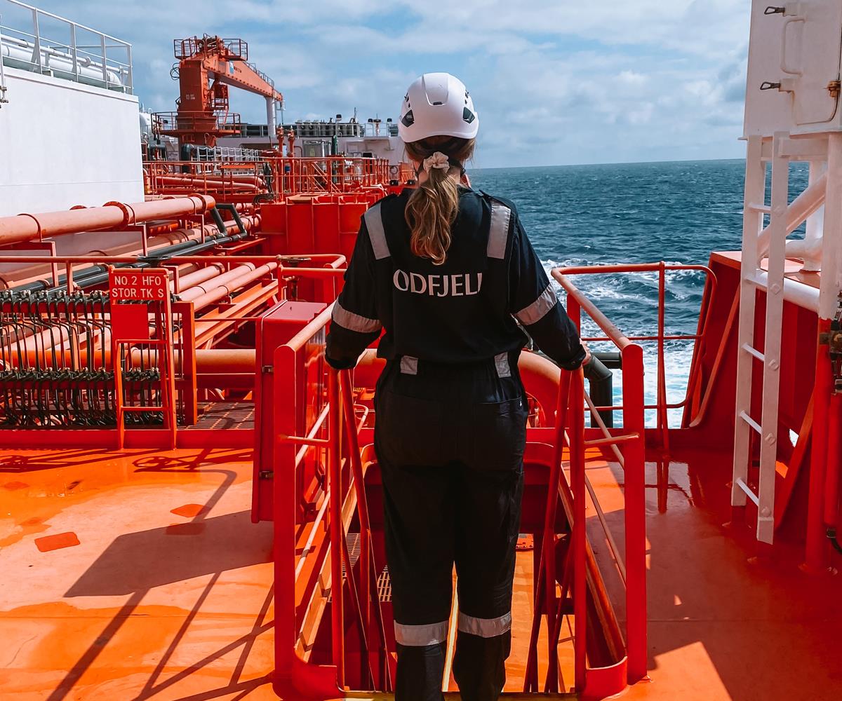 A woman in work gear at work on board a ship