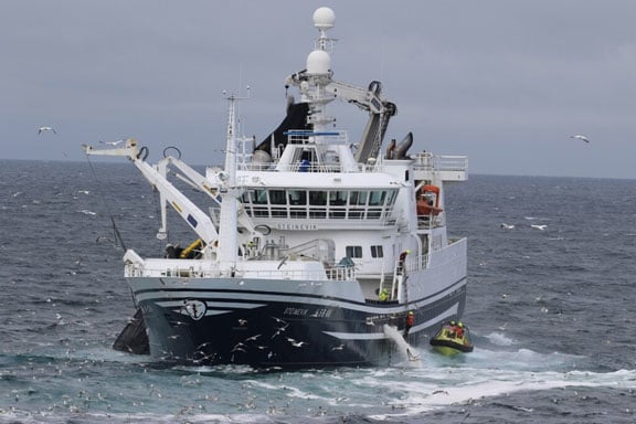 Figure 5.2 Fishing vessel during fishing operations, showing Coast Guard personnel boarding for inspection.