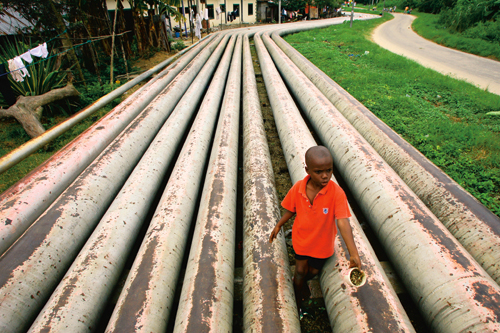 Figure 4.2 Oil pipelines running through a Nigerian village.