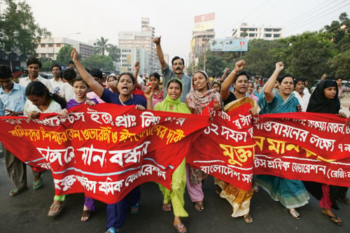 Figure 7.3 Textile workers in Bangladesh protest against the killing of
 several demonstrators by the police during a demonstration to demand
 payment of statutory holiday pay.