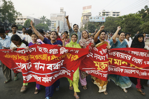 Figur 7.3 Tekstilarbeidere i Bangladesh protesterer mot at flere arbeidere
 ble drept av politiet under en demonstrasjon hvor de krevde utbetaling
 av lovfestede feriepenger.