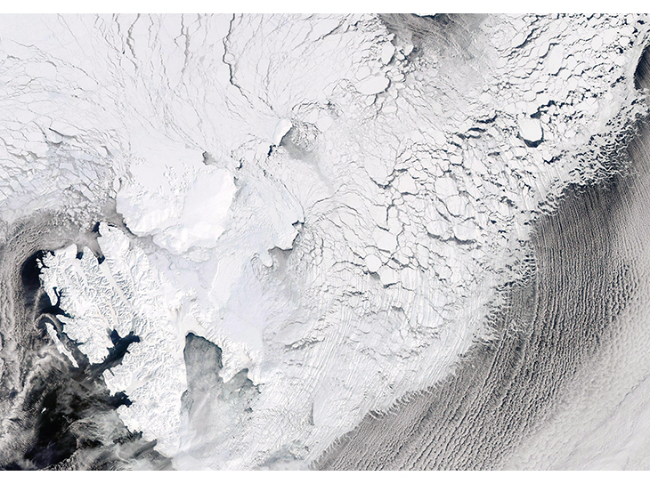 Figure 2.9 Satellite image of ice cover east of Svalbard on 19 April 2013. The image shows a system of large and small ice floes with leads and openings between them that extends far into the drift ice from the fractured outer part of the zone. The fast ice in ...