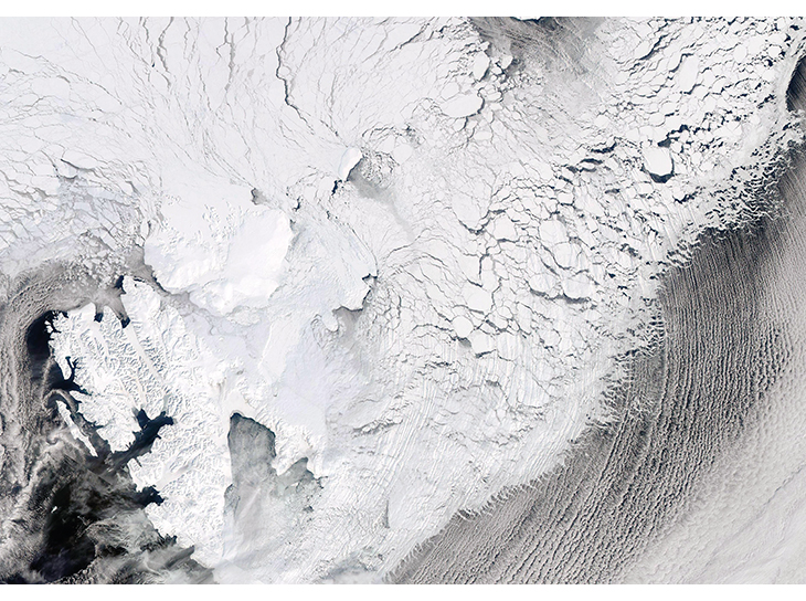 Figure 2.9 Satellite image of ice cover east of Svalbard on 19 April 2013. The image shows a system of large and small ice floes with leads and openings between them that extends far into the drift ice from the fractured outer part of the zone. The fast ice in ...
