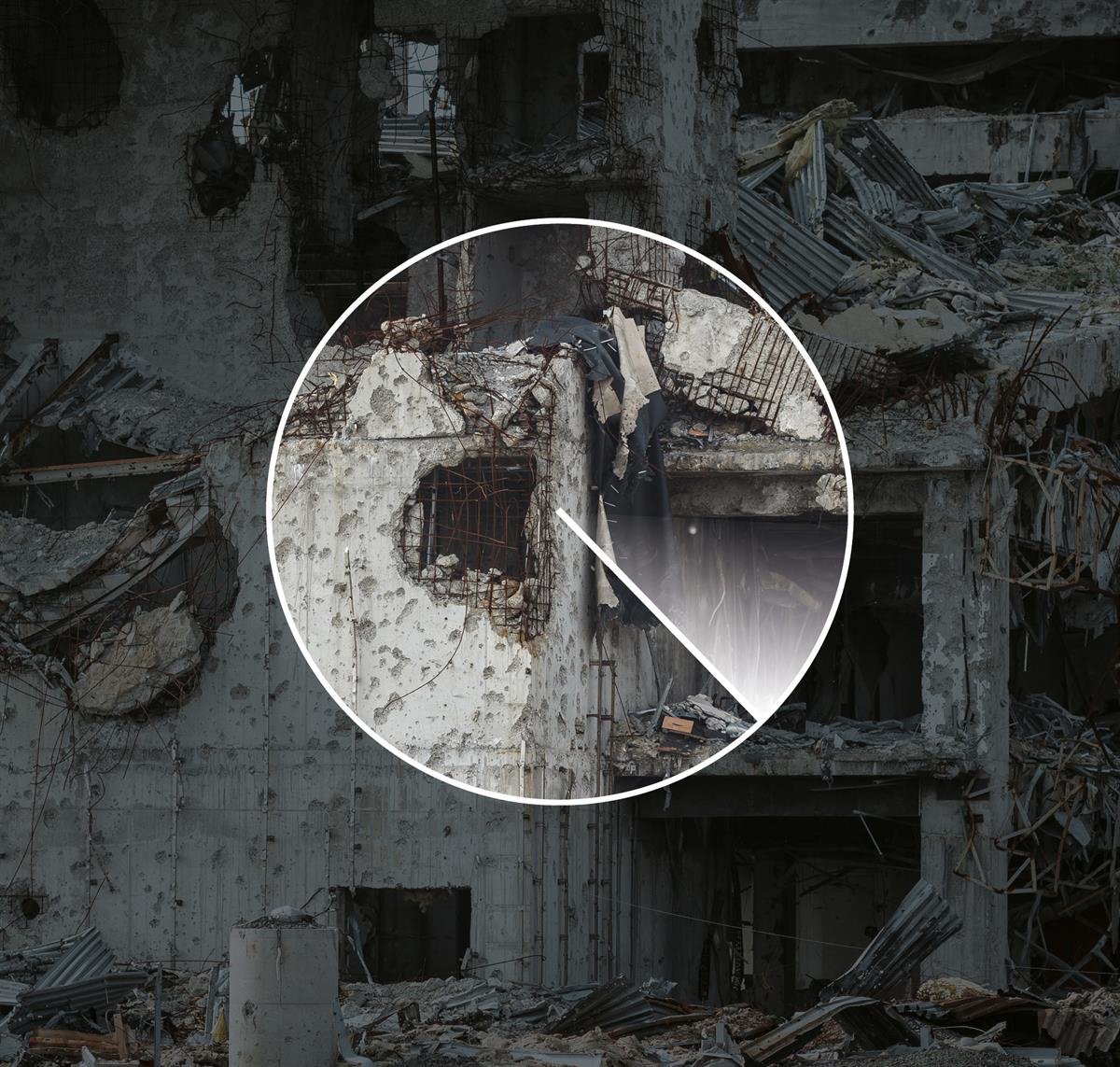 A bombed-out building with collapsed walls and large amounts of concrete and metal debris.