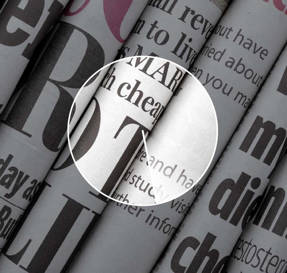 The picture illustrates freedom of the press by showing a section of a number of paper newspapers.