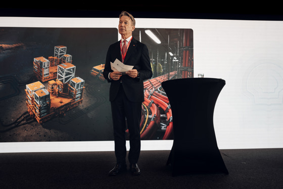 The Minister of Energy is on a stage, holding the official opening speech.