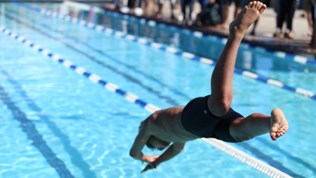 Illustration photo: Young boy diving into a pool for competition.