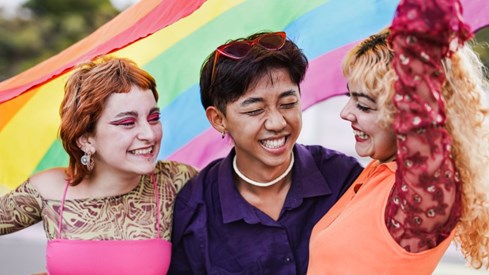 Three young people with a pride-flag. Photo: Gettyimages