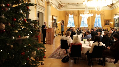 Fra Parkveien 45 hvor statsministeren står ved talerstolen foran norsk presse, som sitter rundt runde bord.