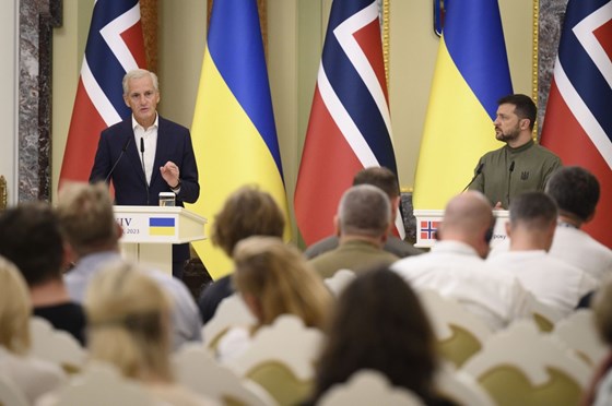 Statsminister Jonas Gahr Støre og Ukrainas president Volodymyr Zelenskyj står ved hver sin talerstol på en pressekonferanse i Kyiv. Norske og ukrainske flagg i bakgrunnen.