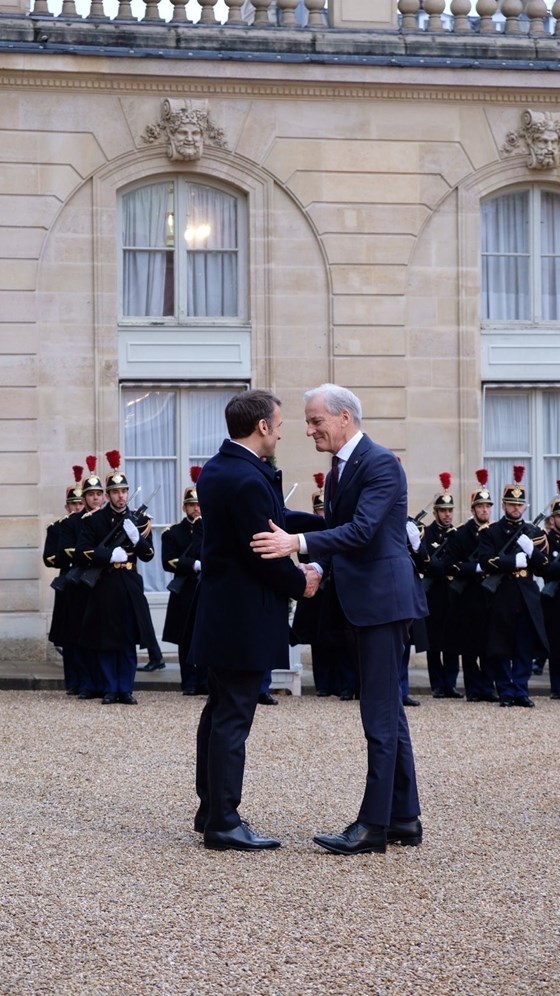 Macron og Støre hilser på hverandre.