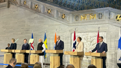Statsministrene i Norden og India står bak hver sin talerstol i Oslo rådhus.