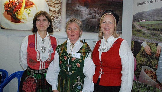 Tre vakre damer i bunad på messe i Arkhangelsk